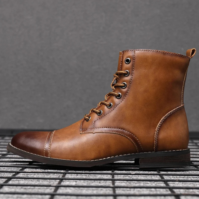 Tan leather cap-toe boot with lace-up front and pull tab detail