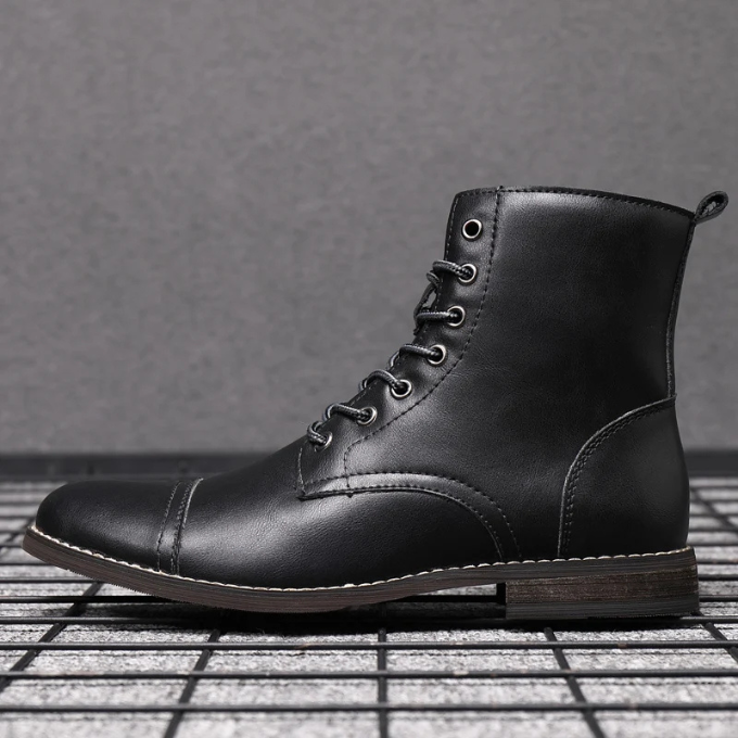 Black leather lace-up boot with round toe and cream stitched sole