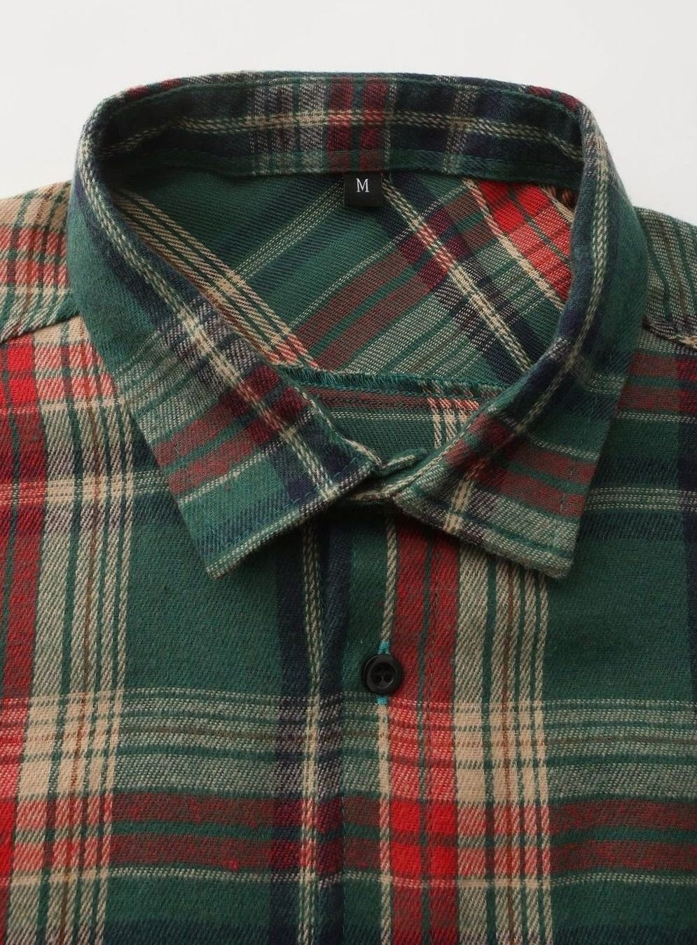 Close-up of collar and button placket on green plaid flannel shirt