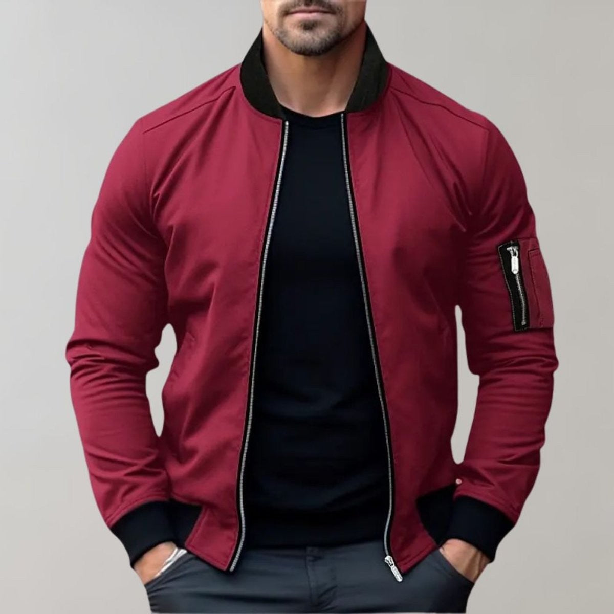 Burgundy bomber jacket with black ribbed collar and sleeve zip pocket, worn open