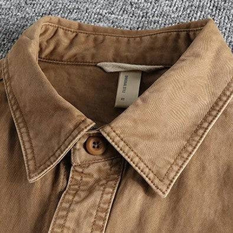 Detailed shot of tan overshirt collar highlighting stitched cotton texture