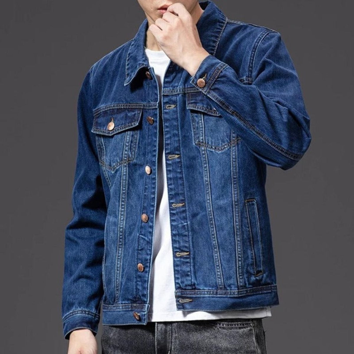 Man wearing dark blue denim jacket with button-up front and chest pockets