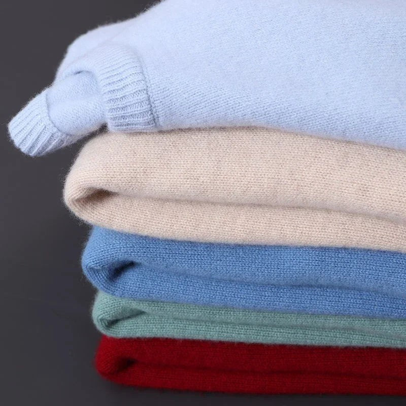 Stack of folded jumpers in blue, cream, navy, green and red
