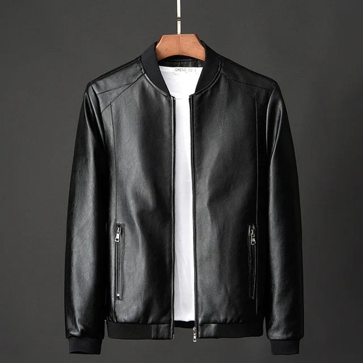 Black faux leather bomber jacket with ribbed trim and zip pockets