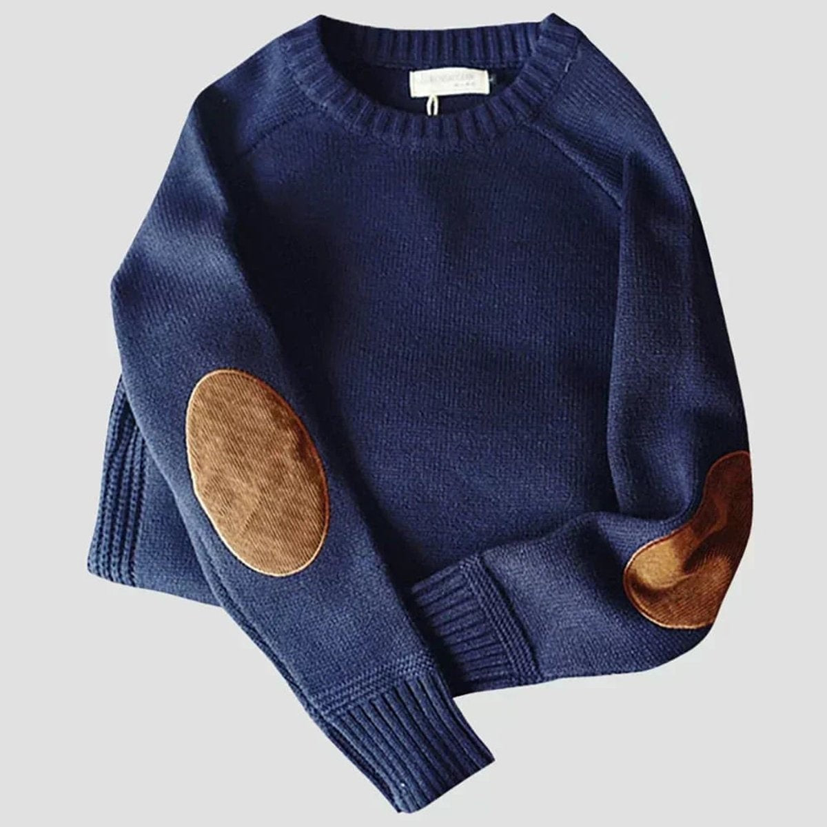Navy ribbed knit jumper displaying tan elbow patches and folded cuffs