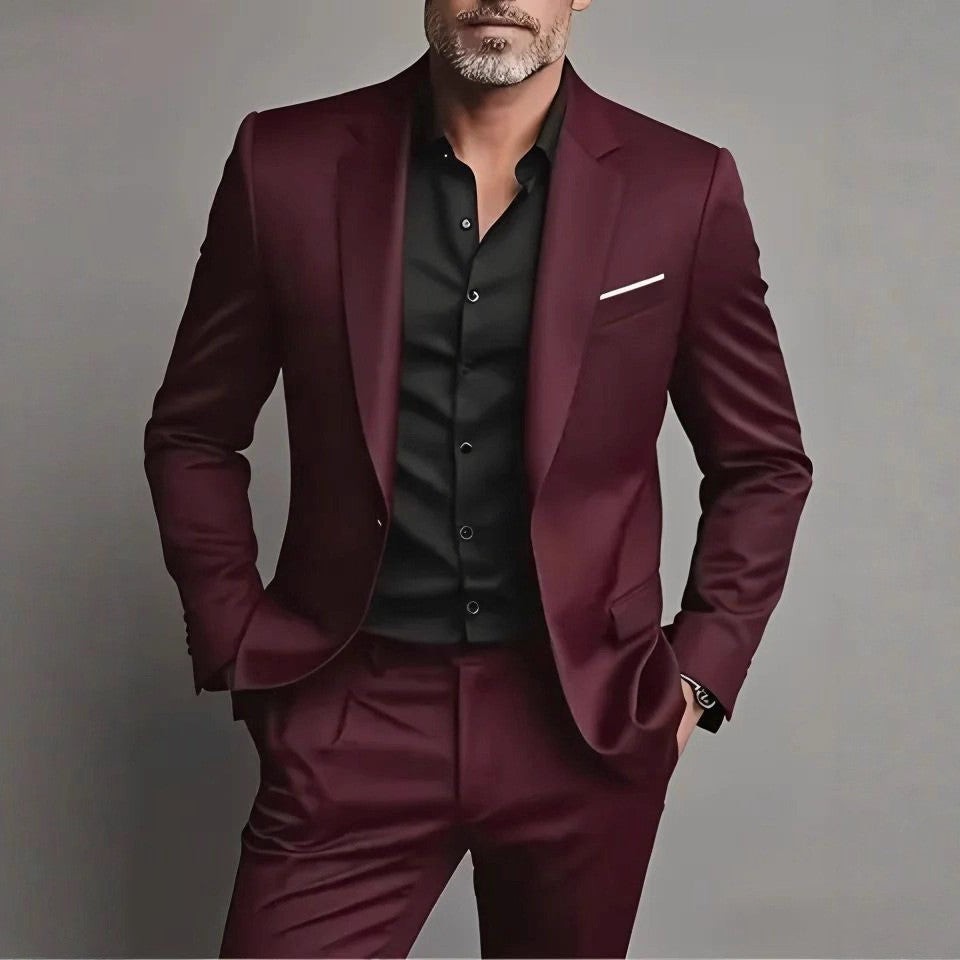 Burgundy skinny suit worn with a black shirt and pocket square detail