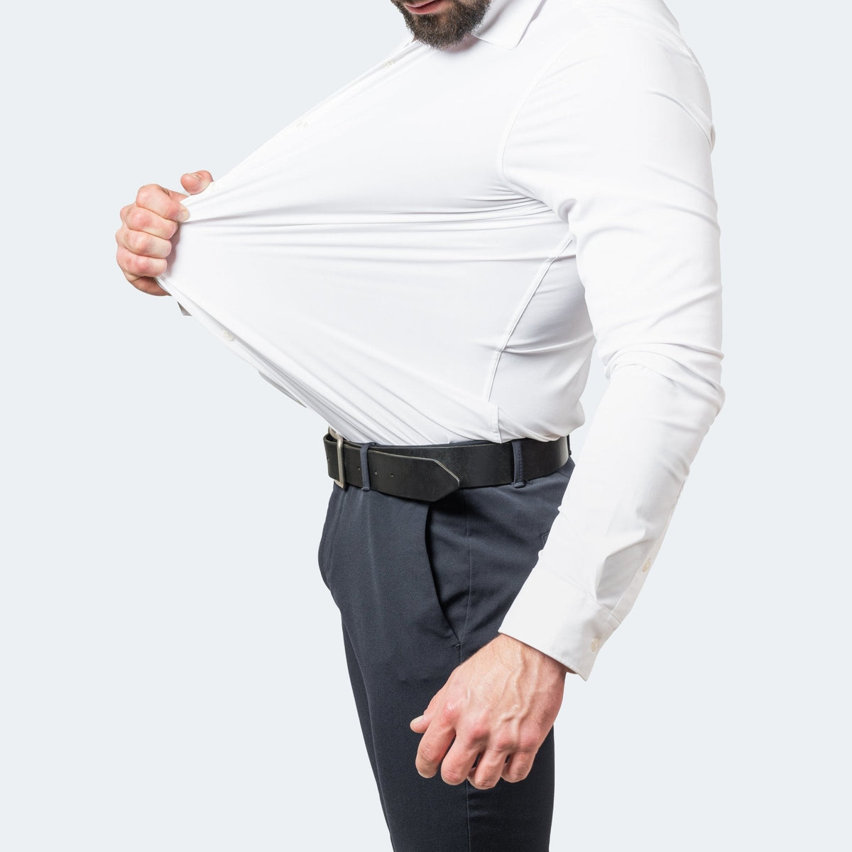 Close-up of white stretch shirt being pulled taut across torso
