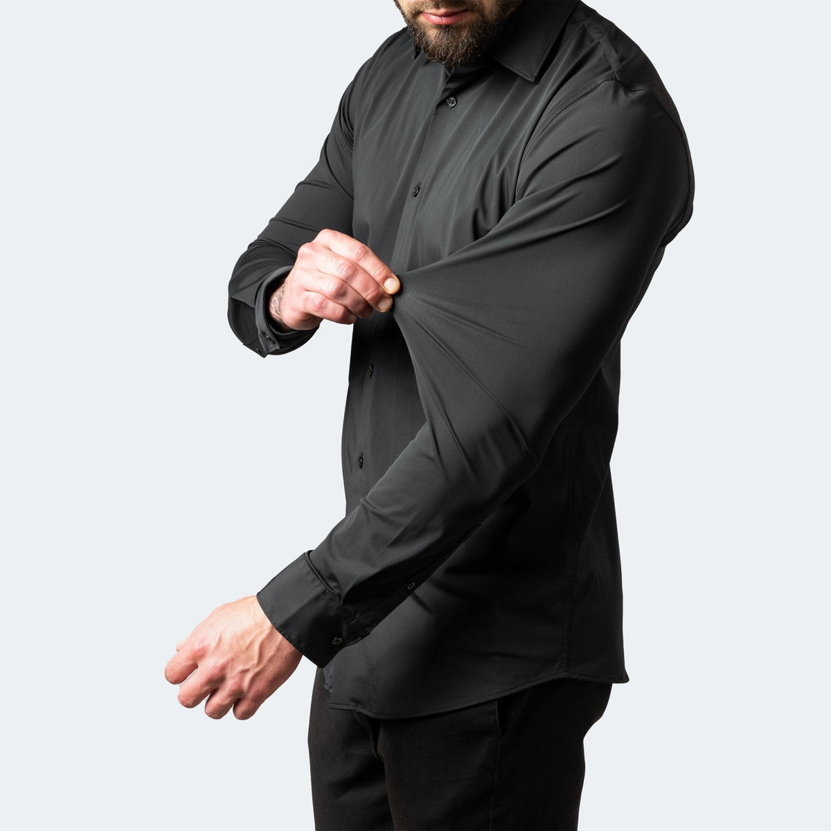 Black stretch shirt sleeve pulled taut to display stretchy material