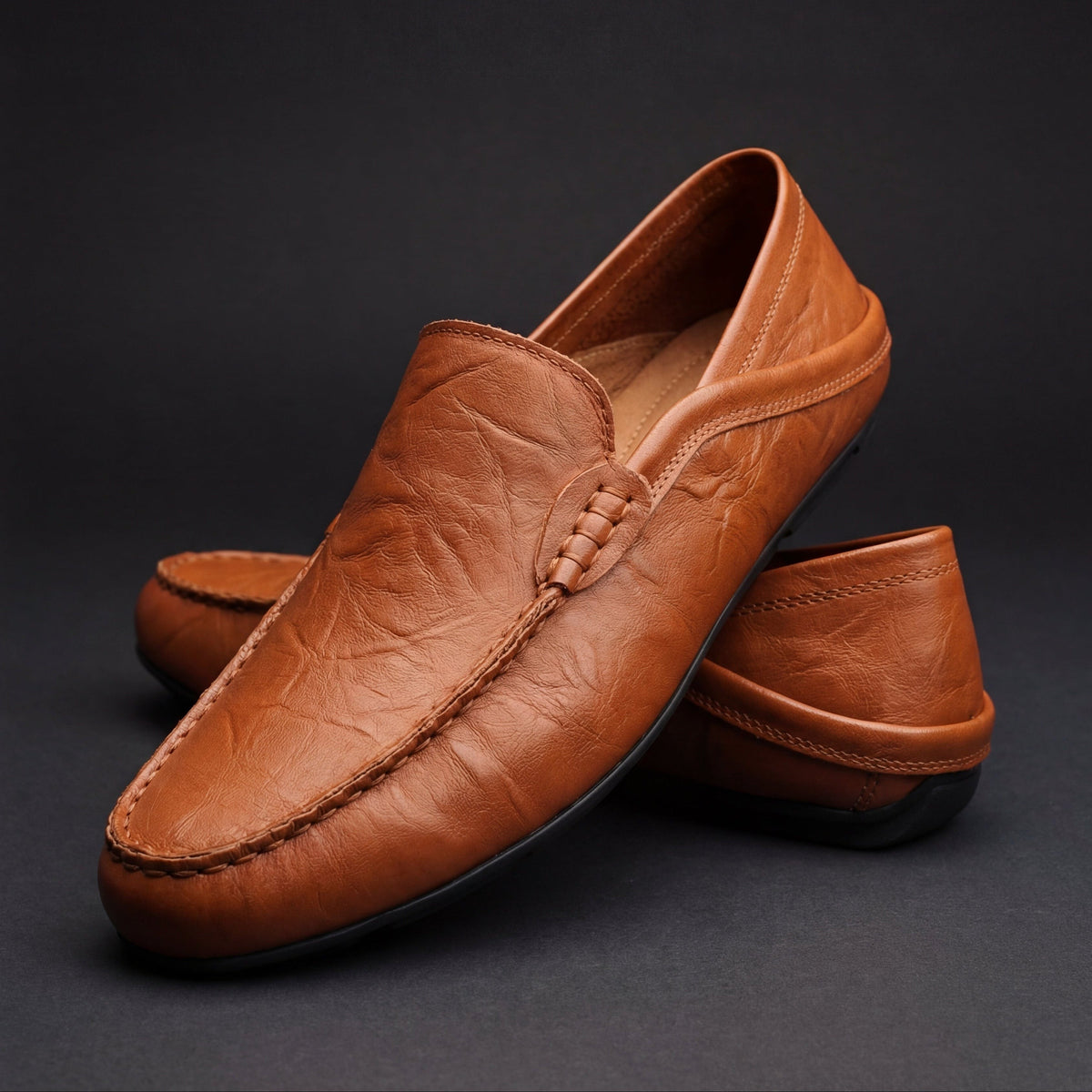 Cognac leather slip-on moccasins with hand-stitched trim and tan lining