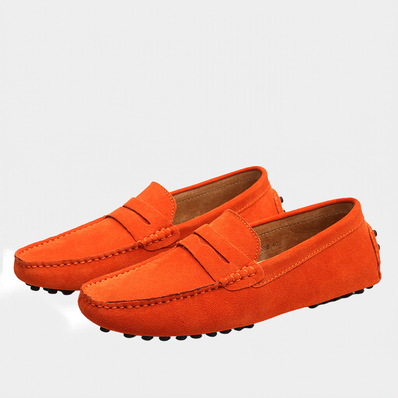 Bright orange suede loafers with tan leather lining and studded sole