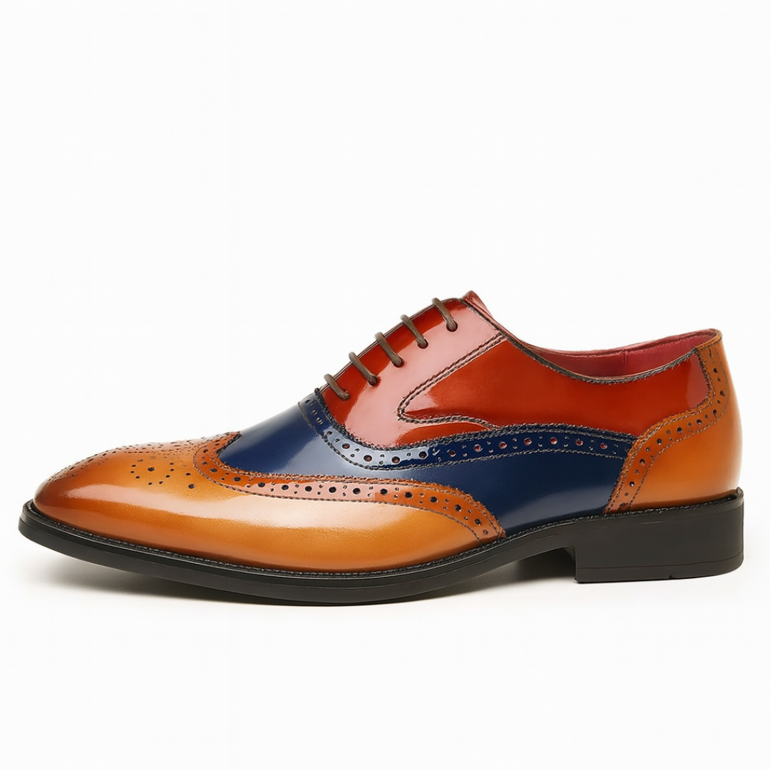 Side profile of tri-colour leather brogue shoe with wingtip perforations