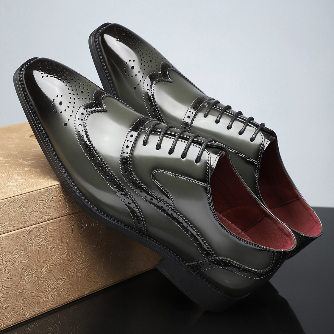 Pair of olive green leather wingtip brogues with polished finish