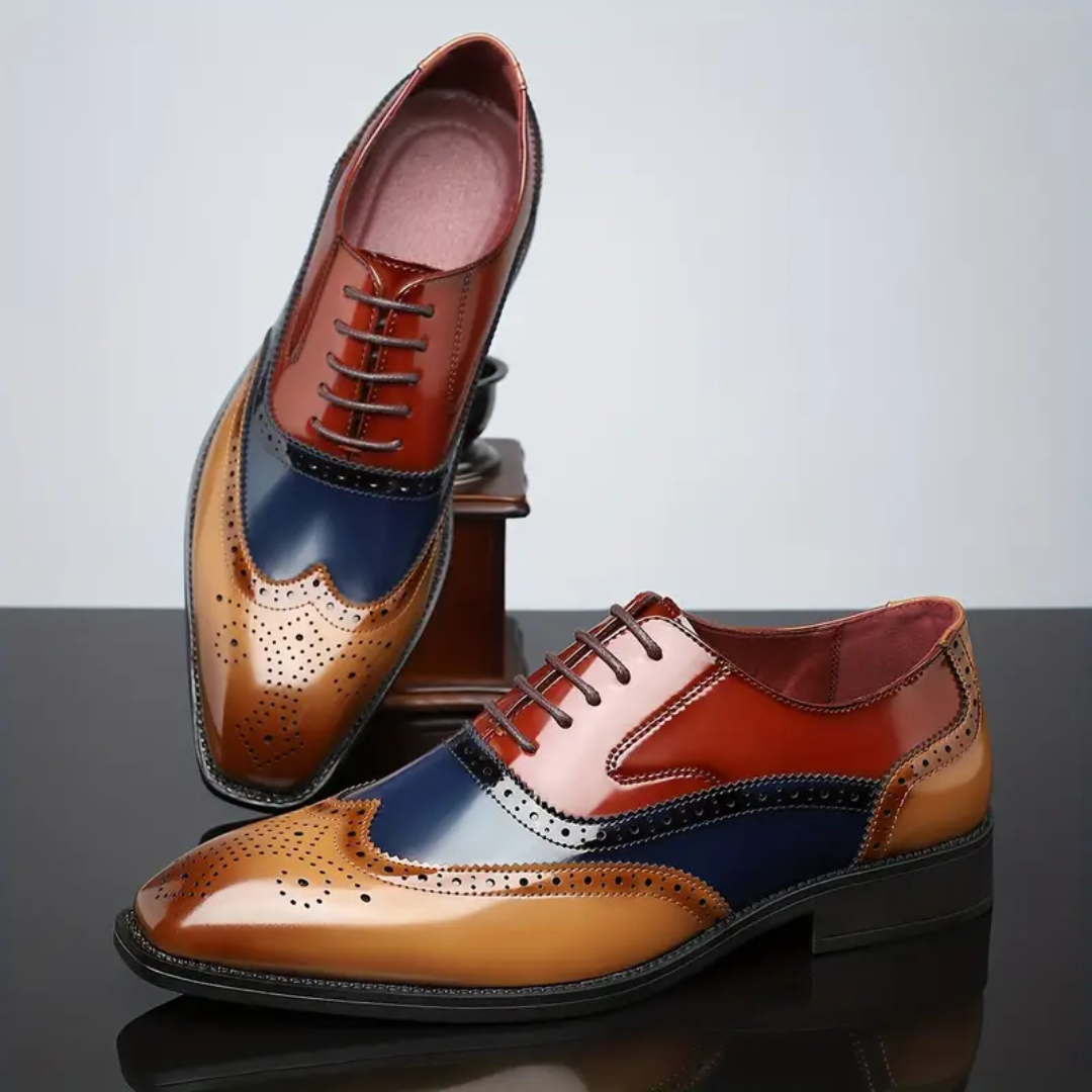 Pair of multicoloured leather brogues displayed beside wooden ornament