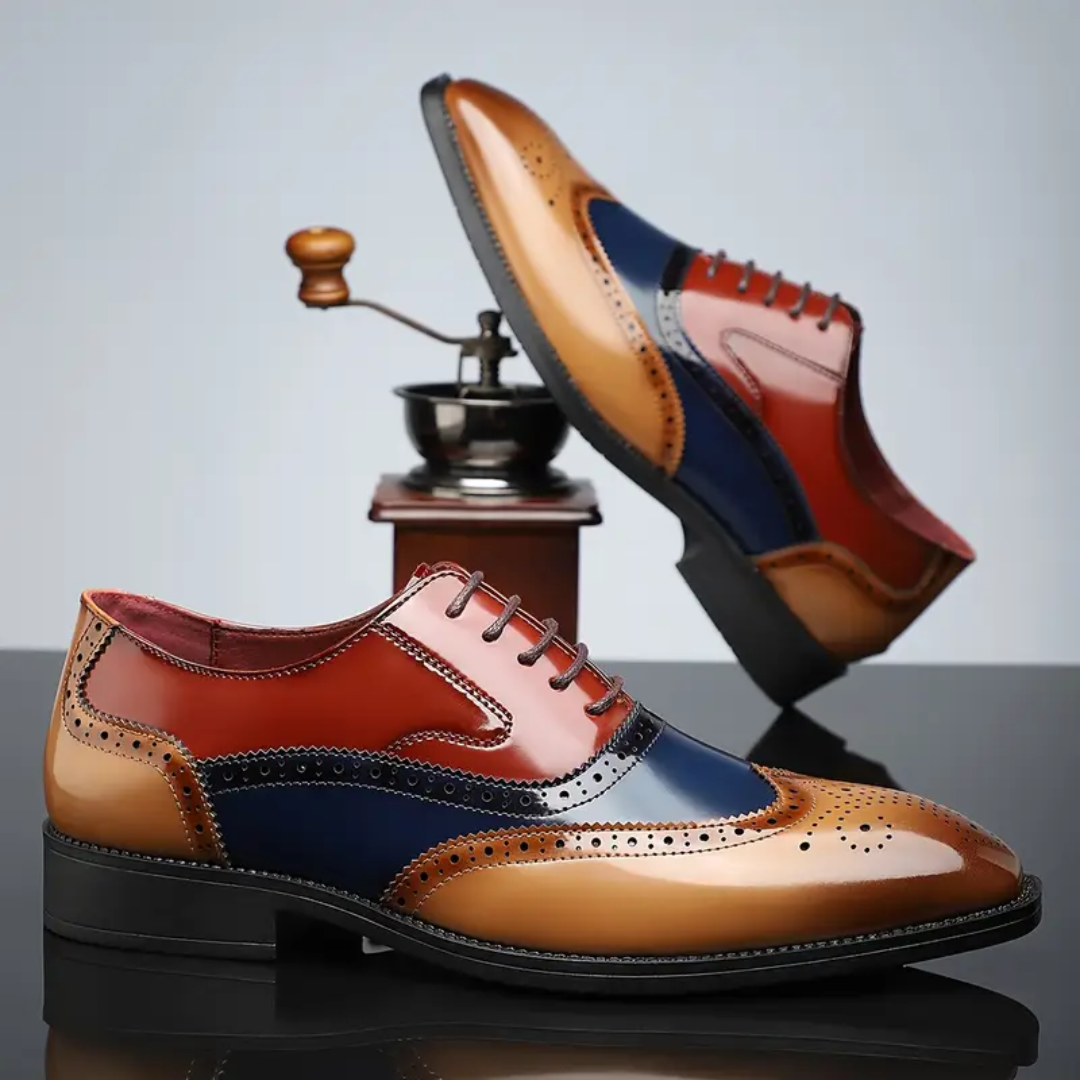 Tan, red and navy leather brogues posed near vintage coffee grinder