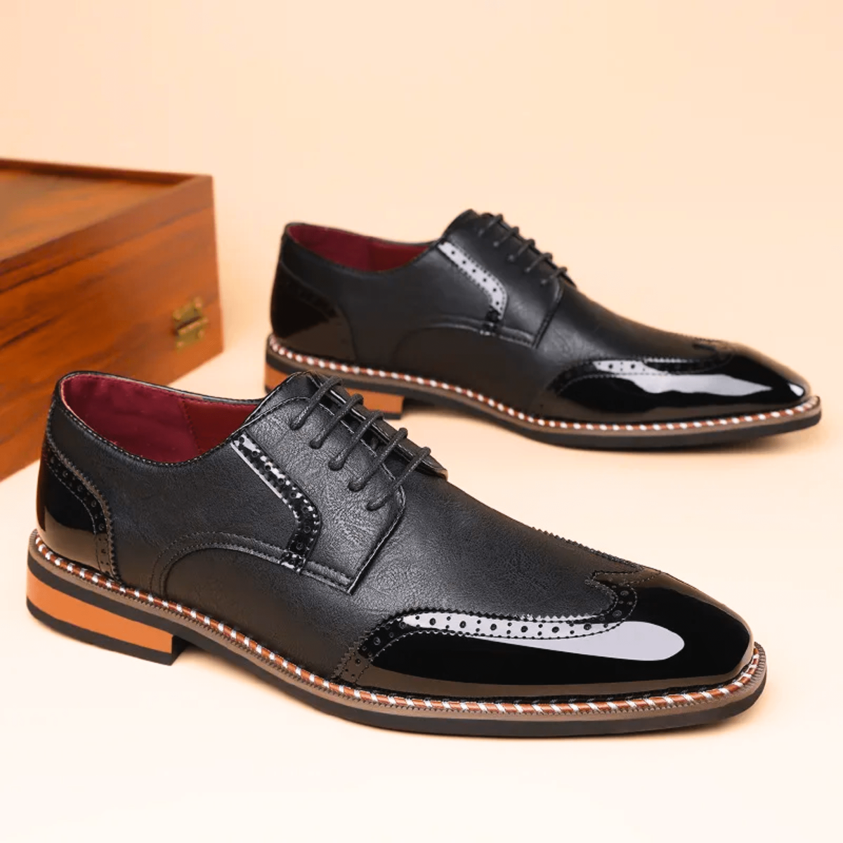 Pair of black patent leather brogue shoes with square toe design