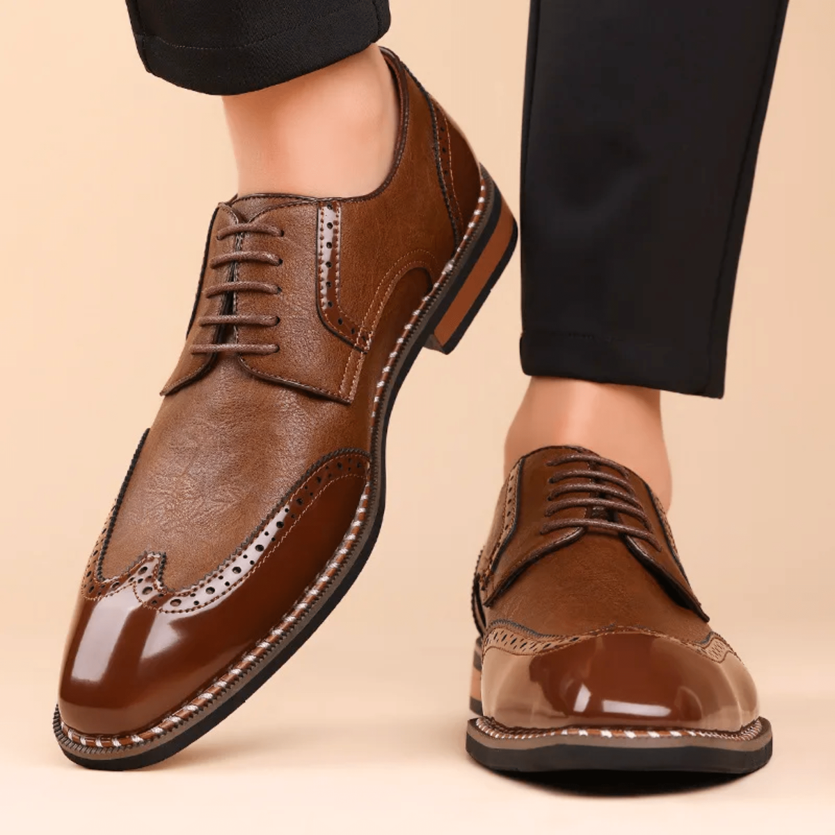Man modelling black leather brogue shoes with patent wingtip toe