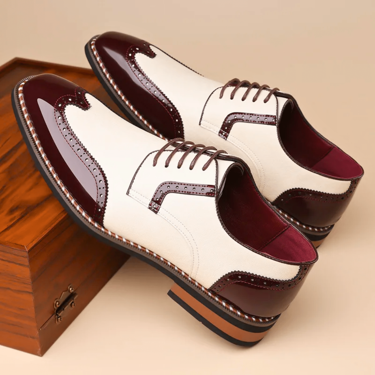 Pair of cream and burgundy two-tone brogue shoes with wingtip detailing