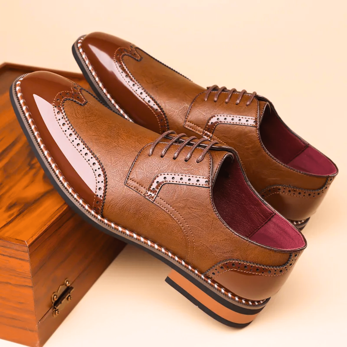 Pair of tan and brown brogue derby shoes with patent leather toe caps