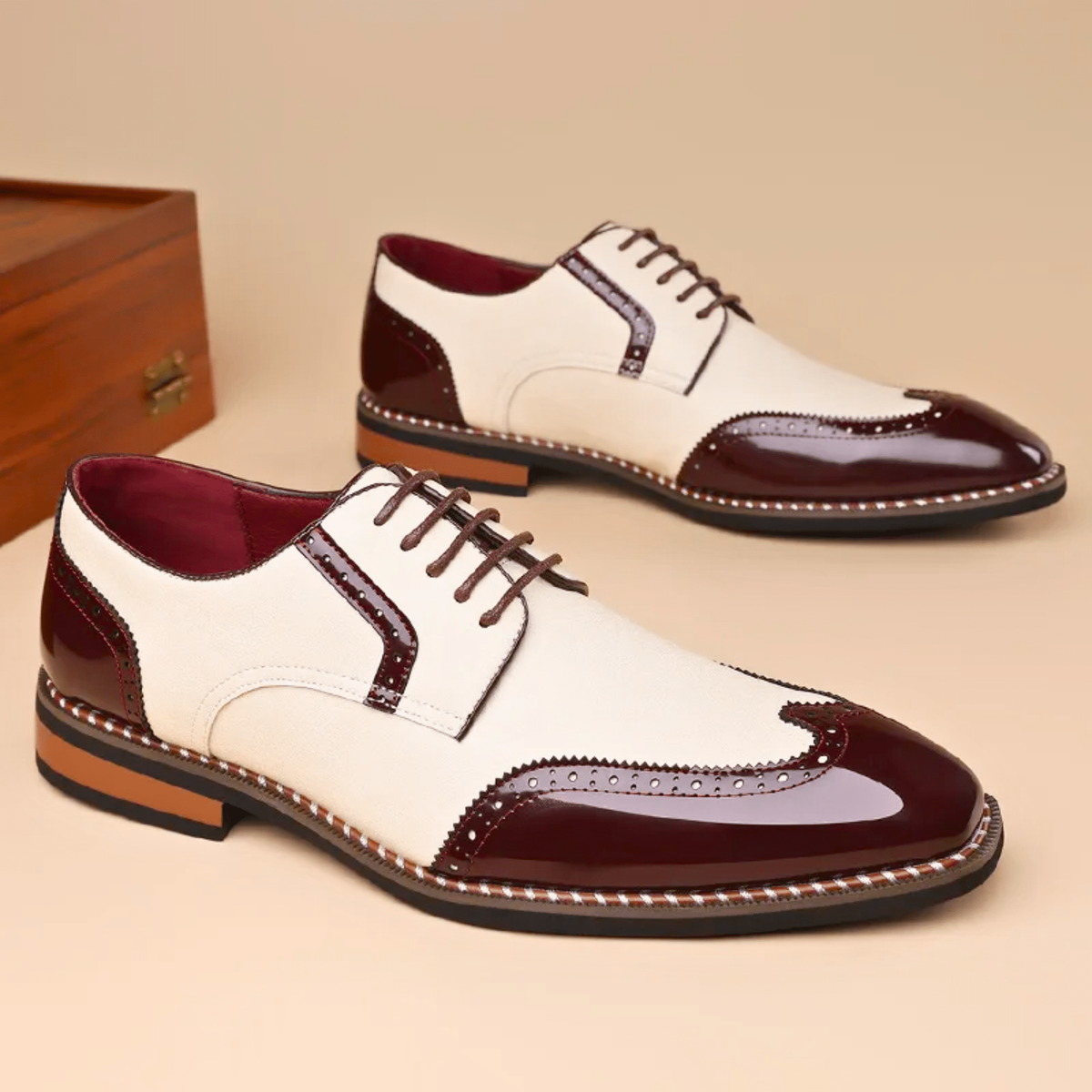 Pair of burgundy and cream patent leather wingtip brogue shoes