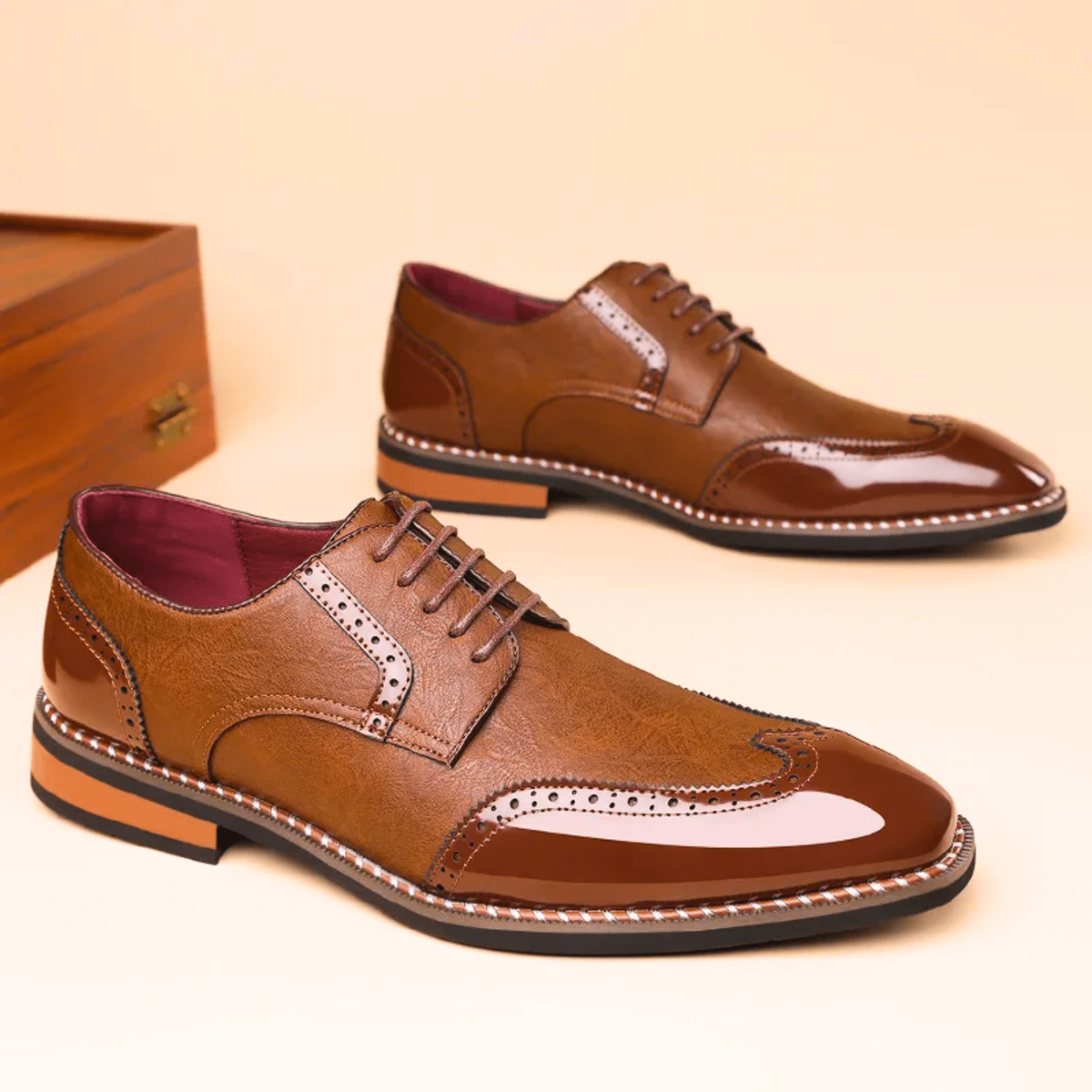 Pair of tan leather brogue derby shoes with glossy patent toe caps